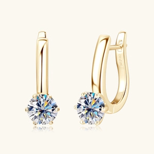 Close-up of golden S925 silver hoop earrings featuring round six-prong moissanite stones