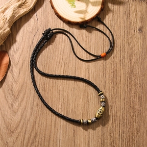 Handmade football necklace with braided leather cord and vintage metal beads