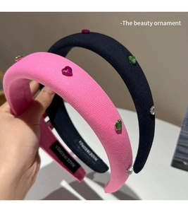 Detail of pink and black padded headbands with colorful rhinestone heart embellishments