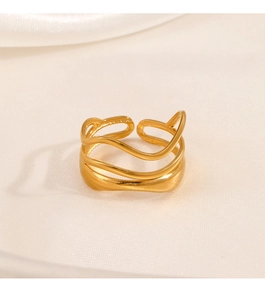 Close-up of 18K gold plated multi-layered wave ring on elegant cream satin fabric