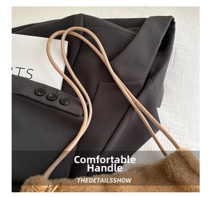 Detail view of the soft brown faux fur bag showing the light-colored leather shoulder straps