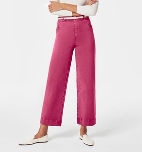 Detail view of women's rose red wide leg jeans with white thin belt and denim texture