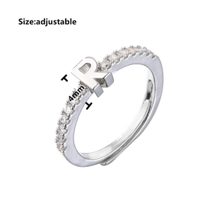 Detailed macro view of silver adjustable ring featuring a micro-paved zircon letter R