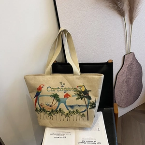 Detail of tropical parrot print and Cartagena lettering on large beige linen tote bag