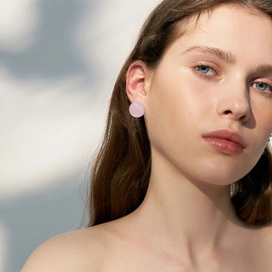 Elegant round pink stud earrings for women featuring a minimalist polished stone design