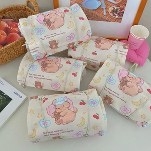 Detail of four-in-one organizer bags with cute star and puppy prints and roll-up design