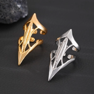 Gothic punk metal armor rings in gold and silver finish on a dark textured background