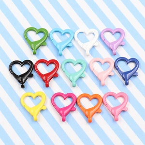 Macro view of thirteen colorful heart-shaped lobster clasps for bags and keychains