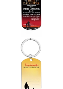 Detail of stainless steel dog tag keychains with father-daughter silhouettes and text