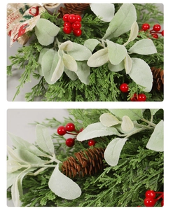 Detail of frosted pine needles with red berries and pinecones on a Christmas teardrop swag