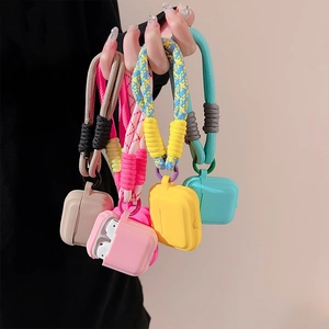 Close-up of colorful silicone AirPods cases with braided lanyards in five vibrant colors