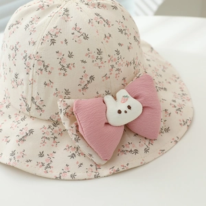 Cute floral baby sun hat with pink bow and bunny plush for summer travel protection