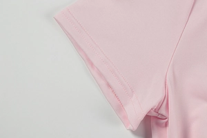 Macro detail of high-quality double-needle stitching on pink summer dress sleeve cuffs