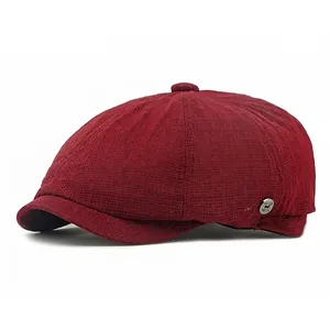 Classic dark red checkered newsboy cap in British retro style with a metal side badge