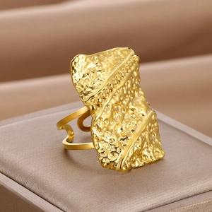 Detailed macro view of gold rectangular ring featuring a unique molten lava texture finish