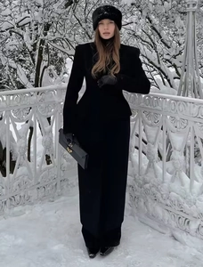 Detail of wool coat with lapel collar paired with leather gloves and winter accessories