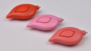 Three leaf-shaped personal safety alarms in red, pink, and orange with keychains