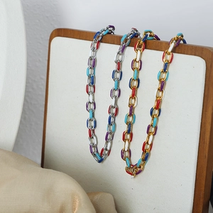 Colorful enamel link jewelry set with gold and silver base chains on white display