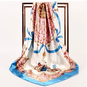 Close-up of vintage horse carriage silk scarf with gold baroque and blue ribbon motifs