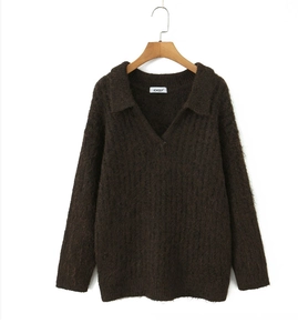 Detail of dark brown knit sweater featuring fuzzy texture and classic polo collar