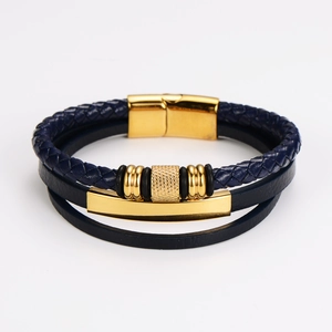 Detail of dark blue multilayer braided leather bracelet with golden magnetic clasp