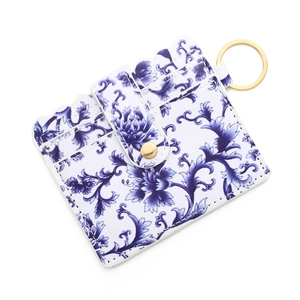 Detail of blue floral PU leather card holder with scalloped edges and gold keychain ring