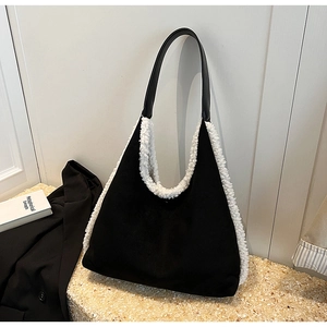 Minimalist black suede tote bag with white faux fur trim and leather shoulder straps