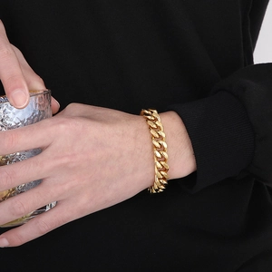 Polished gold Cuban link chain bracelet on wrist with high detail fashion showcase