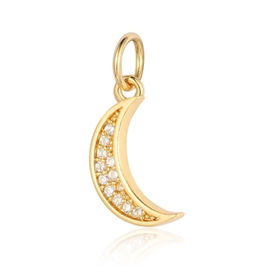 Macro detail of crescent moon pendant with gold plating and sparkling zircon stones