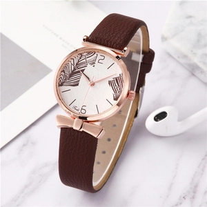 Detailed macro of a women's quartz watch with a brown feather pattern and leather strap