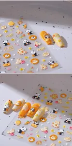 Close-up of 3D panda embossed nail stickers with vibrant orange and yellow star patterns