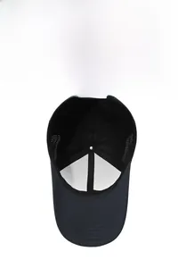 Detailed view of breathable mesh side panels and adjustable metal buckle on navy baseball cap