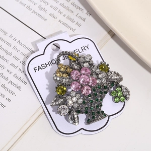 Macro detail of a vintage silver flower basket brooch with multi-color rhinestones