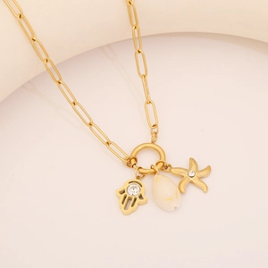 Golden starfish shell necklace with Hamsa hand pendant and sparkling zircons