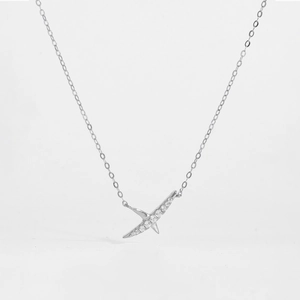 Detailed close-up of a silver starburst pendant necklace with shimmering zircon stones