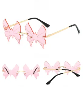 Three-view layout of rimless butterfly sunglasses with pink lenses and gold metal temples