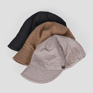 Cotton canvas newsboy cap in black, brown and grey with metal logo and wide brim
