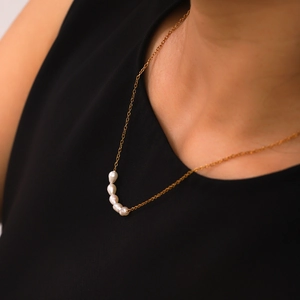Close-up of 18K gold-plated stainless steel chain with five natural freshwater pearls