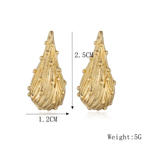 Detail view of gold teardrop earrings with ribbed texture and beads, size 2.5cm by 1.2cm