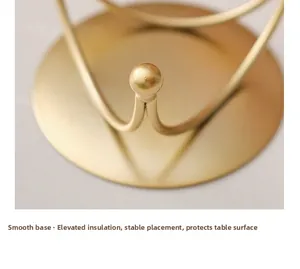 Close-up of golden iron candle tray with elevated insulated base and smooth edges