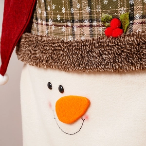 Detail of snowman chair cover showing textured fabric and plaid hat with faux fur trim