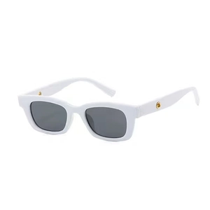 Detail of white rectangular sunglasses featuring grey lenses and gold round side accents