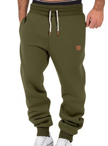 Detail of army green joggers featuring elastic cuffs and white drawstring waist cord
