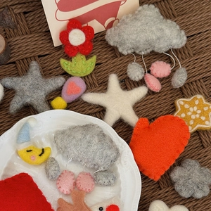 Handmade wool felt shapes including stars and hearts for DIY bouquet Christmas decor