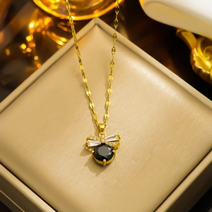 Elegant gold titanium steel necklace with bee pendant featuring a black stone and crystals