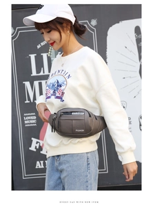 Street style shot of waterproof dark brown waist bag with white fashion lettering for men