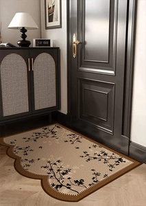 Detail of French vintage PVC door mat with black floral patterns and brown wavy edges