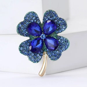 Exquisite blue crystal four-leaf clover brooch with green enamel and gold stem detailing