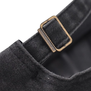 Close-up of vintage bronze metal buckle and washed fabric texture on baseball cap
