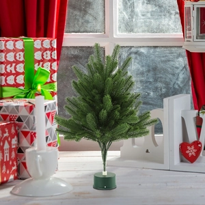 Mini tabletop Christmas tree on a festive windowsill with cozy holiday decorations